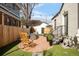 Inviting backyard with stone patio, outdoor seating, string lights, and well-maintained landscaping at 945 Jackson St, Denver, CO 80206