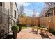 Beautiful backyard featuring a stone patio, rocking chairs, manicured planters and string lights at 945 Jackson St, Denver, CO 80206