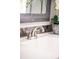 Close-up of bathroom sink, detailing the faucet, granite countertop, and decorative plants at 945 Jackson St, Denver, CO 80206