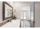 Bathroom features a granite countertop vanity, with an exterior view through an open door at 945 Jackson St, Denver, CO 80206