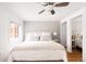 Comfortable bedroom featuring a queen-size bed, a ceiling fan, and closet space at 945 Jackson St, Denver, CO 80206