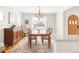 Inviting dining room with vintage wooden furniture, lighting fixture, and hardwood floors at 945 Jackson St, Denver, CO 80206