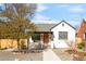 Charming home featuring a well-maintained yard, arched doorway, and freshly painted exterior at 945 Jackson St, Denver, CO 80206