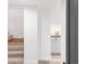 Bright hallway with stairs and a glimpse of the modern kitchen at 945 Jackson St, Denver, CO 80206