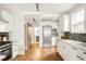 Well-designed kitchen with stainless steel appliances, white cabinets and hardwood floors at 945 Jackson St, Denver, CO 80206