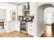 Modern kitchen features stainless steel appliances, stylish backsplash, and hardwood flooring at 945 Jackson St, Denver, CO 80206