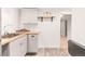 Bright kitchen area with light-colored cabinets, butcher block counter and wood floors at 945 Jackson St, Denver, CO 80206