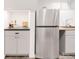 Kitchen area features stainless steel refrigerator, sink and storage at 945 Jackson St, Denver, CO 80206