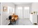 Sunlit living room with hardwood floors, a vintage settee, and a crisp white dresser at 945 Jackson St, Denver, CO 80206