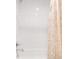 Modern bathroom shower with white tile and decorative shower curtain at 945 Jackson St, Denver, CO 80206