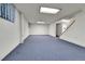 Unfinished basement featuring blue carpet, white walls and ceiling tiles, ready to be customized at 460 S Taft St, Lakewood, CO 80228
