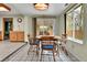Cozy dining area with wood table, cushioned chairs, and large windows at 460 S Taft St, Lakewood, CO 80228