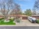Charming single-story home with a well-maintained lawn, mature trees, and a two car garage at 460 S Taft St, Lakewood, CO 80228