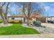 Charming home with manicured front lawn, rock garden, mature trees, and inviting curb appeal at 460 S Taft St, Lakewood, CO 80228