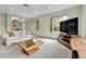 Bright living room featuring neutral tones, large windows, and comfortable seating arrangements at 460 S Taft St, Lakewood, CO 80228