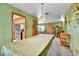 Cozy living room with green walls, carpeted floor, and view into the kitchen at 460 S Taft St, Lakewood, CO 80228