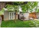 View of backyard shed with small porch and nice landscaping, offering outdoor storage at 840 Essex Dr, Denver, CO 80229