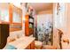 Charming bathroom featuring a vanity, toilet, and a shower with a floral-patterned curtain at 840 Essex Dr, Denver, CO 80229