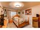 Comfortable bedroom with a wooden bed frame, floral accents, and a light-filled ambiance at 840 Essex Dr, Denver, CO 80229