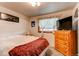 Cozy bedroom showcasing a bed, window, dresser, carpet floors, and a calming ambiance at 840 Essex Dr, Denver, CO 80229
