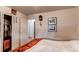 Bedroom with a bed and a view of closet and hallway with carpet and hard wood flooring at 840 Essex Dr, Denver, CO 80229