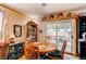Cozy dining area with a round wood table and chairs, leading to a patio through sliding glass doors at 840 Essex Dr, Denver, CO 80229