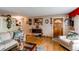 Cozy living room with hardwood floors, comfortable seating, and vintage accents at 840 Essex Dr, Denver, CO 80229