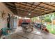 Covered patio with tile flooring, ceiling, table, grill, outdoor seating, and decor at 840 Essex Dr, Denver, CO 80229