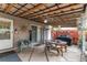 Covered patio offering a dining table, grill, seating area, decor, and access to the backyard at 840 Essex Dr, Denver, CO 80229