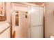Modern tiled shower featuring built-in shelving, sleek glass doors, and contemporary fixtures at 840 Essex Dr, Denver, CO 80229