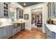 Gray cabinetry, stainless steel sink, wine cooler, hardwood floors at 559 N Williams St, Denver, CO 80218