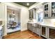 Gray cabinetry, stainless steel sink, wine cooler, hardwood floors at 559 N Williams St, Denver, CO 80218