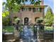Brick home with ornate iron gate and landscaping at 559 N Williams St, Denver, CO 80218