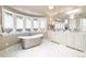Luxurious bathroom with a freestanding tub, dual vanities, and marble flooring at 559 N Williams St, Denver, CO 80218