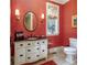 Elegant powder room with a white vanity, coral walls, and a stylish mirror at 559 N Williams St, Denver, CO 80218