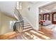 Curved staircase with wrought iron railing and hardwood floors at 559 N Williams St, Denver, CO 80218