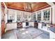 Bright sunroom features built-in desks, hardwood floors, and ample natural light at 559 N Williams St, Denver, CO 80218