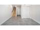 Open entryway featuring tile floors, a staircase, and convenient closet space, perfect for a welcoming foyer at 3520 W Conejos Pl # 11, Denver, CO 80204