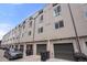 Modern townhome exterior with private garages and ample parking spaces at 3520 W Conejos Pl # 11, Denver, CO 80204