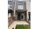 Charming brick townhouse featuring an inviting entrance with modern awning and well-maintained landscaping at 3520 W Conejos Pl # 11, Denver, CO 80204