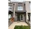Charming townhome featuring brick facade and covered entryway, offering a welcoming curb appeal at 3520 W Conejos Pl # 11, Denver, CO 80204