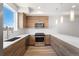 Well-equipped kitchen with stainless steel appliances, light wood cabinetry, and ample countertop space for cooking at 3520 W Conejos Pl # 11, Denver, CO 80204