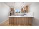 Bright kitchen featuring wood cabinets, stainless steel appliances, an island, and stylish pendant lighting at 3520 W Conejos Pl # 11, Denver, CO 80204