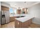 Modern kitchen featuring stainless steel appliances, wooden cabinetry, sleek countertops and stylish pendant lighting at 3520 W Conejos Pl # 11, Denver, CO 80204