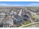 Areal view shows the home nestled in a well-planned community featuring houses, streets, and open spaces at 10610 Reunion Pkwy, Commerce City, CO 80022