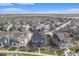 The community spans across the landscape, showcasing houses in harmony with their surroundings under a clear sky at 10610 Reunion Pkwy, Commerce City, CO 80022