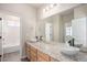 Bathroom with double sink vanity, large mirror, and adjacent shower at 10610 Reunion Pkwy, Commerce City, CO 80022