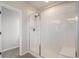 A tiled walk-in shower features sliding glass doors and a built-in bench at 10610 Reunion Pkwy, Commerce City, CO 80022