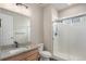 Bathroom featuring granite countertop, faucet, and tiled walk-in shower at 10610 Reunion Pkwy, Commerce City, CO 80022