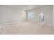 Spacious bedroom with neutral carpet and a window providing natural light at 10610 Reunion Pkwy, Commerce City, CO 80022